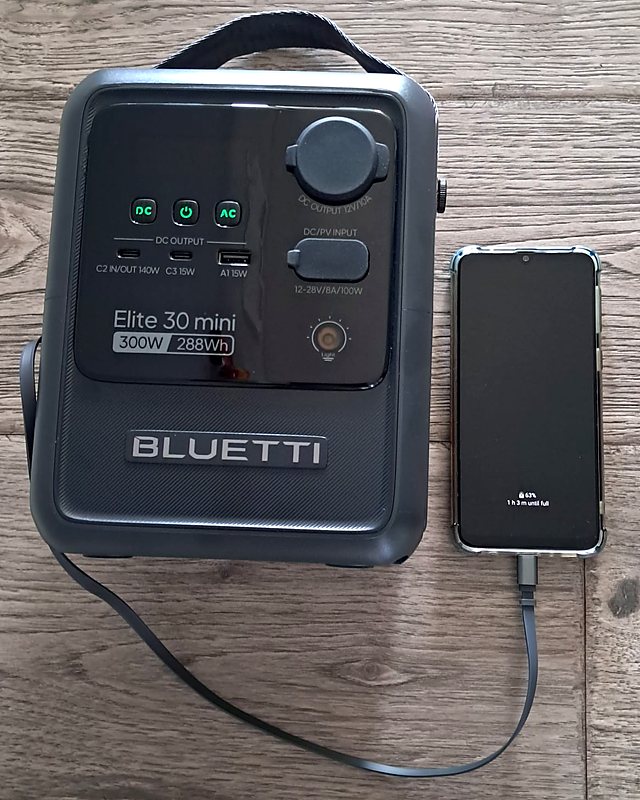 Bluetti Elite 30 Mini charging a smartphone through its built-in retractable USB-C cable